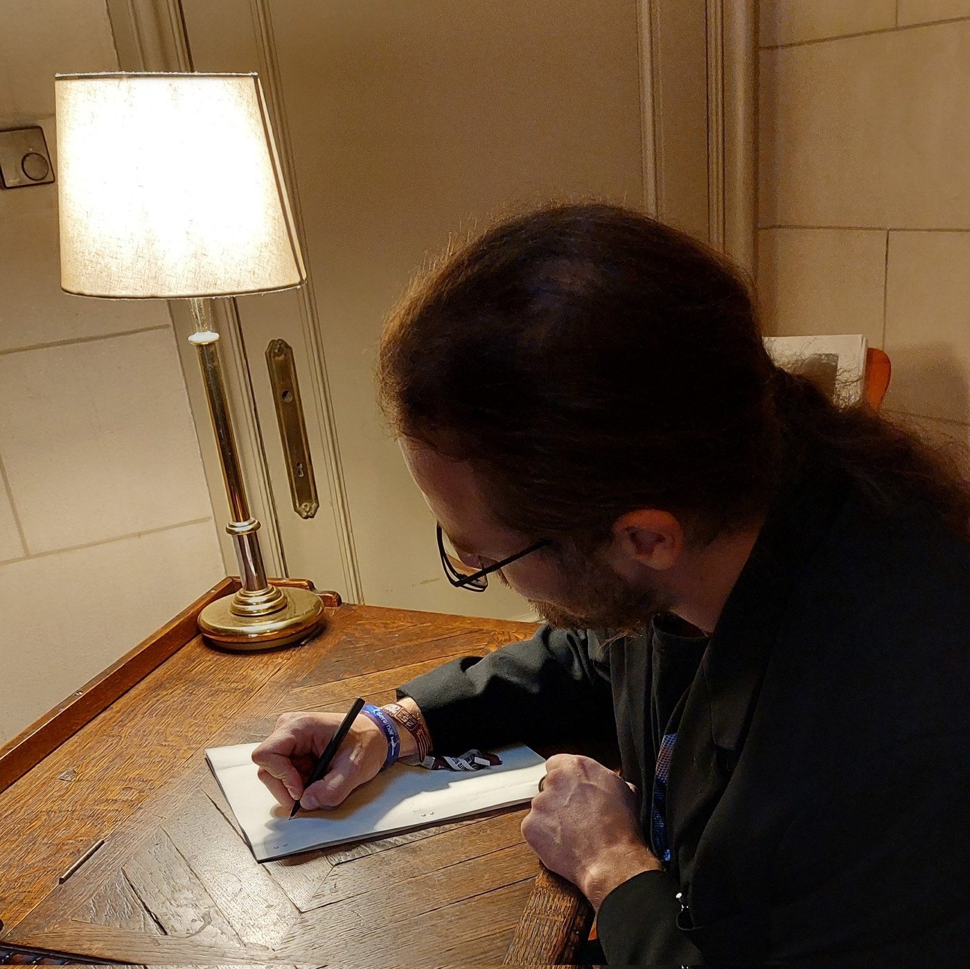 Daniel Z Hastings writing at a desk